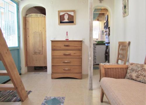 a living room with a dresser and a kitchen at Asklipion Valley guest house in Kos Town