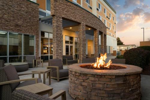 a fire pit in the courtyard of a building at Courtyard by Marriott Fayetteville Fort Liberty - Spring Lake in Spring Lake