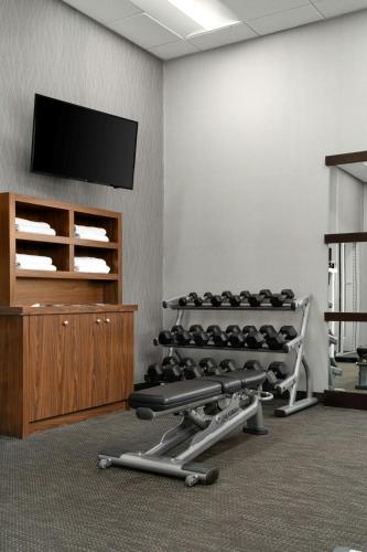 a room with a gym with a flat screen tv at Courtyard by Marriott Fayetteville Fort Liberty - Spring Lake in Spring Lake