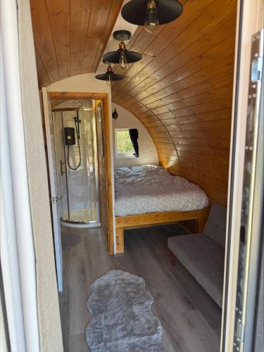 a bedroom with a bed in a tiny house at Springfield oaks Glamping Pod in Isle of Wight