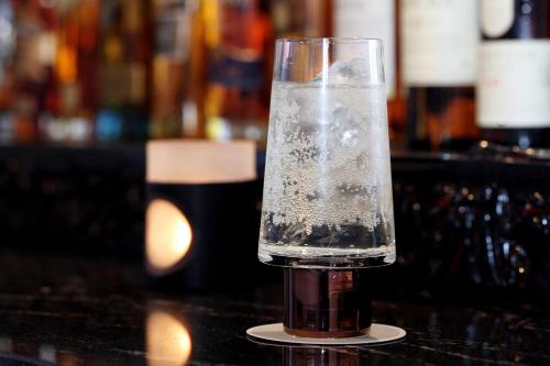 a glass of water sitting on top of a table at Fujinohana Hotel in Kirishima