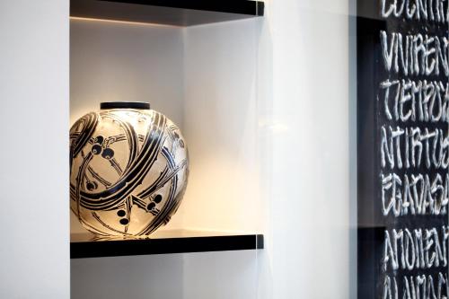 a vase sitting on a shelf in a display case at Fujinohana Hotel in Kirishima