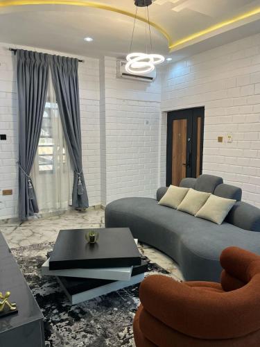 a living room with a couch and a table at Grand T Abode Luxury Apartment in Ibadan