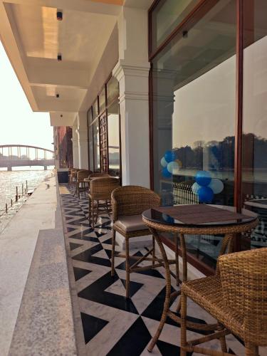 a row of tables and chairs on a balcony with a view at Gauri Gangaa in Haridwār
