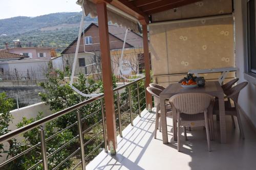 a balcony with a table and chairs on a balcony at Lana's House in Berat
