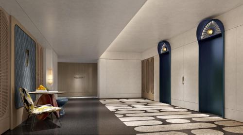 a hallway with blue and white walls and a table and chairs at voco Xishuangbanna Gaozhuang by IHG in Jinghong