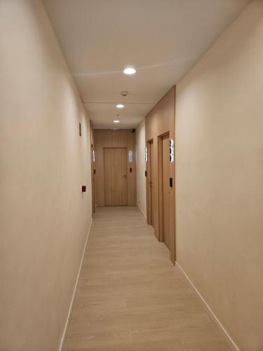 a hallway with wooden doors and a long corridor at El Globo in Valencia
