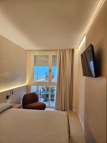 a hotel room with a bed and a window at El Globo in Valencia