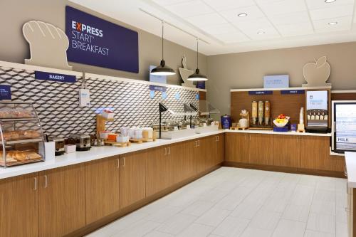a fast food restaurant with a counter with food at Holiday Inn Express & Suites Charlotte - Airport Area in Charlotte