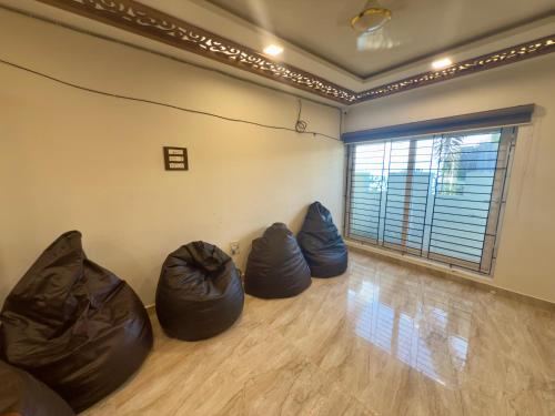 a room with three bean bags on the floor at POCOYO - BACKPACKERS HOSTEL - Omr in Chennai