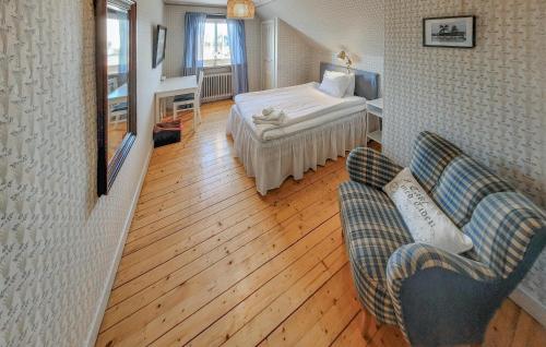 a living room with a bed and a couch and a room at Lovely Apartment In Åseda With Wifi in Åseda