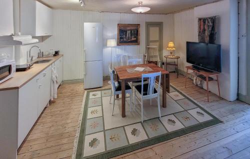 a kitchen with a wooden table and a refrigerator at Lovely Apartment In Åseda With Wifi in Åseda