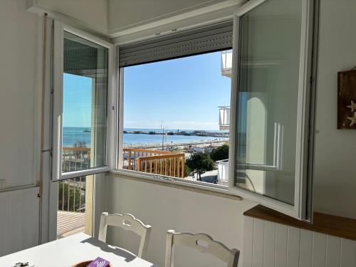 a dining room with a view of the ocean at La Corte Dei Mari Acquamarina in Cesenatico