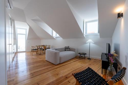 a living room with a white couch and a table at Sunny Lisbon Apartments by Soulplaces in Lisbon