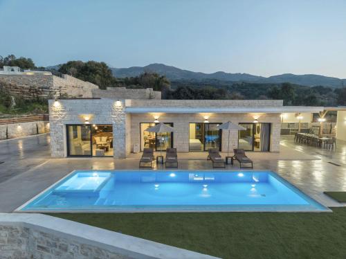a swimming pool in the backyard of a villa at Villa Lux Solis - With 2 Pools in Khoumérion