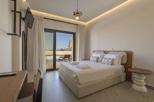a bedroom with a bed and a table and a desk at Villa Lux Solis - With 2 Pools in Khoumérion
