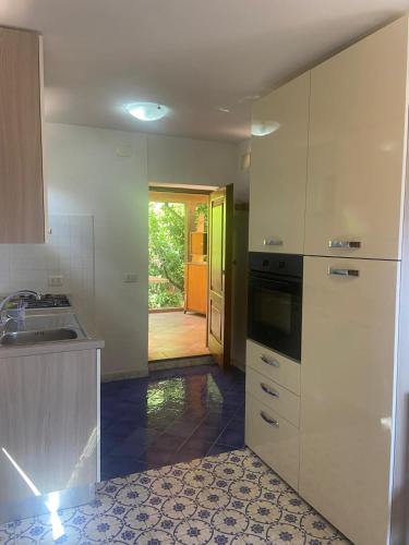 a kitchen with a sink and a stove top oven at Casa Franchino in Pollica