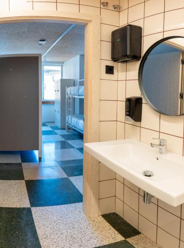 a bathroom with a sink and a mirror at Lamia BBK Women Hostel-Solo mujeres in Bilbao