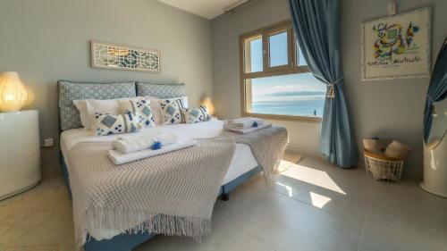 a bedroom with a bed with towels on it at Find me on Kefalonia in Vlachata