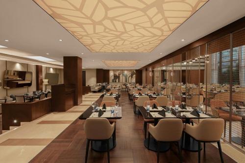 a restaurant with tables and chairs in a room at Sheraton Istanbul Levent in Istanbul