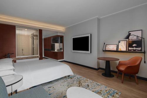 a hotel room with a bed and a tv at Sheraton Istanbul Levent in Istanbul