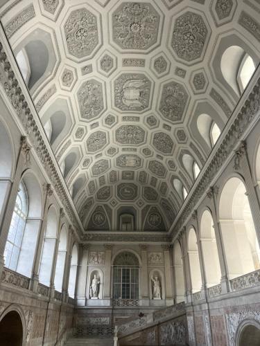an ornate room with a ceiling and windows at Casetta Piazza Plebiscito in Naples