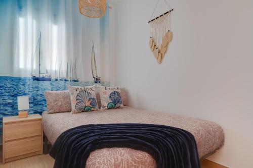 a bedroom with a bed with boats in the window at Horizonte beachfront apartment in Ifach