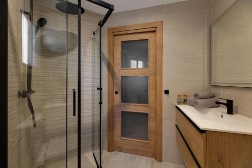 a bathroom with a shower and a glass door at Horizonte beachfront apartment in Ifach