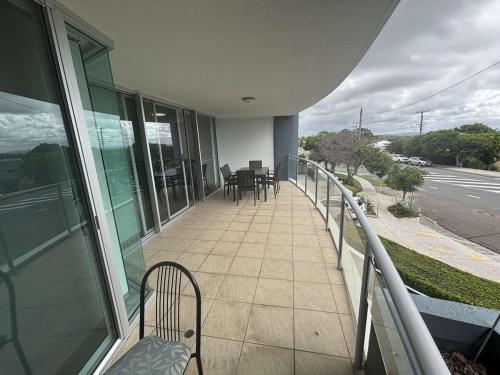 a balcony of a house with a table and chairs at Seaside Sovereign Retreat in Caloundra