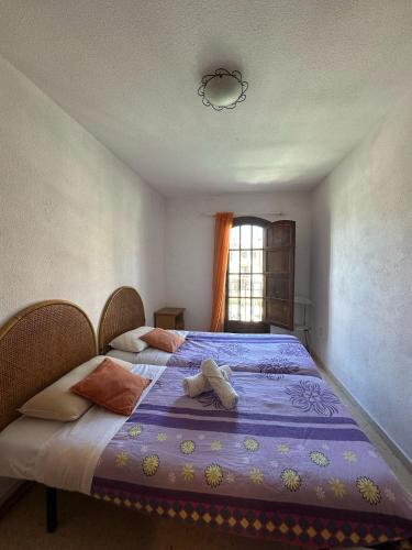 a bedroom with two beds and a window at Port Saplaya 2 habitaciones Valencia in Port Saplaya