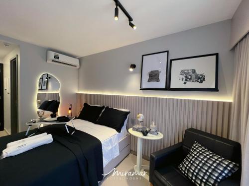 a small bedroom with a bed and a chair at Beach Haus in Tambaú