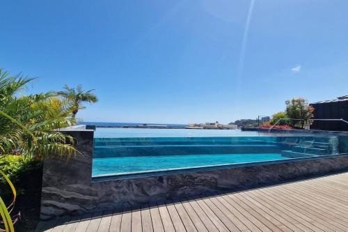 a swimming pool with a view of the ocean at Empire Luxury Suite - Savoy Insular in Funchal