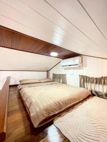 a bedroom with a large bed in a room at Anna River Home A3 in Ban Khlong Si