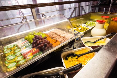 a buffet with meat and grapes and other food at The Gardens Hotel in Manchester