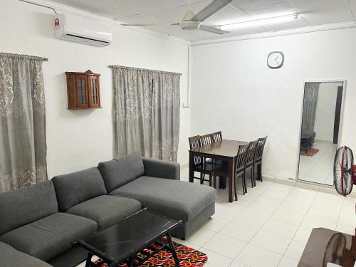 a living room with a couch and a table at Padang Besar Homestay Firdaus in Padang Besar