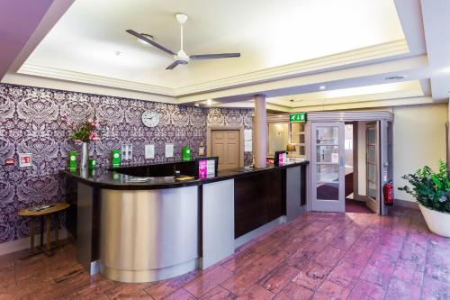a bar in the lobby of a hotel at The Gardens Hotel in Manchester