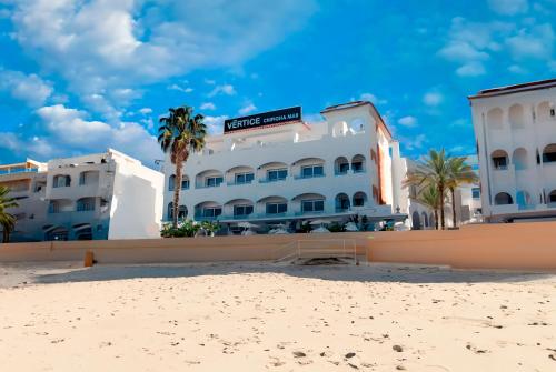 a hotel on the beach next to the beach at Hotel Vértice Chipiona Mar in Chipiona