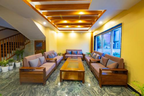 a waiting room with couches and a table at Hotel Quest in Pokhara