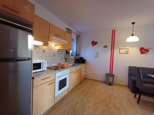 a kitchen with a refrigerator and a stove top oven at Apartment Renn in Uttendorf in Uttendorf