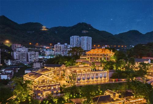 a view of a city at night with buildings at CHONGQING MANQUE MANSION in Chongqing
