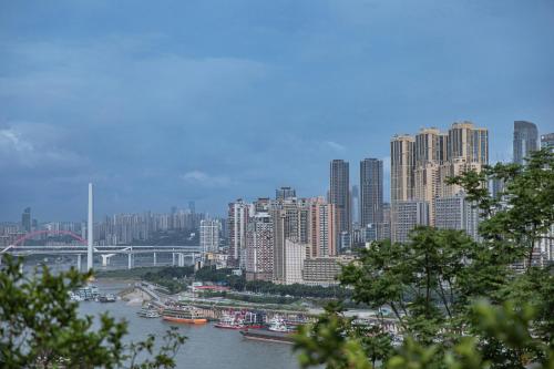 a view of a city with a river and buildings at CHONGQING MANQUE MANSION in Chongqing
