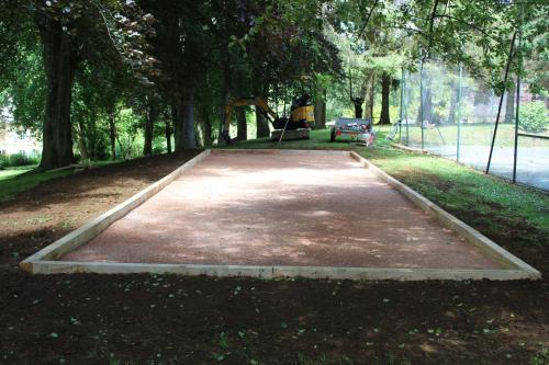 a concrete slab in a park with a bench at Domaine complet de 5 gîtes in Guerquesalles