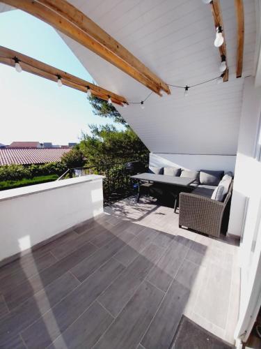 an outdoor patio with a couch and a table at Apartments Filip & Nina in Vir