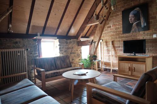 a living room with a couch and a table at Camping Cottesserhoeve in Vijlen