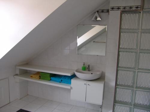 a bathroom with a sink and a mirror at LUNA City Apartman in Sopron