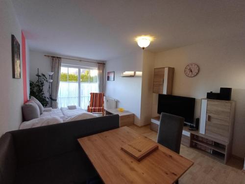 a living room with a bed and a table and a television at Apartment Renn in Uttendorf in Uttendorf