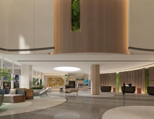 a lobby with couches and tables in a building at EVEN Hotel Wuhan Airport Zone by IHG in Wuhan