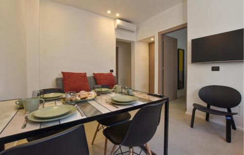 a living room with a table and chairs and a couch at 2 Bedroom Gorgeous Apartment In Trappeto in Trappeto