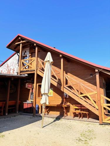 a wooden building with an umbrella in front of it at Penzion Urban in Havířov