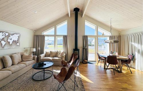 a living room with a couch and a table at 3 Bedroom Cozy Home In Grebbestad in Grebbestad
